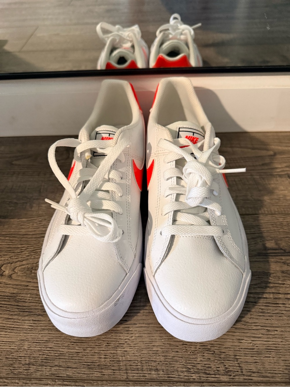 Nike White Sneakers with Bright Orange-Red Swoosh
